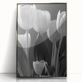 Framed wall art featuring a botanical design of vibrant tulips in shades of pink and yellow, set in a sleek silver frame, ideal for enhancing home decor.