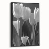 Framed botanical tulip wall art in a sleek black frame, showcasing vibrant flower designs on a canvas, perfect for home decor or art collections.