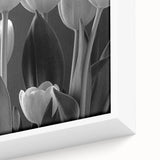Close-up view of a framed botanical tulip wall art piece, showcasing vibrant colors and intricate details on a canvas, perfect for home decor enhancement.