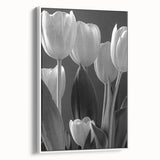 Framed canvas wall art showcasing a botanical tulip design in vibrant colors, displayed in a sleek white frame, enhancing modern decor aesthetics.