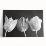 Stretched canvas wall art featuring a vibrant botanical tulip design in shades of pink and green, leaning against a neutral backdrop for an elegant display.