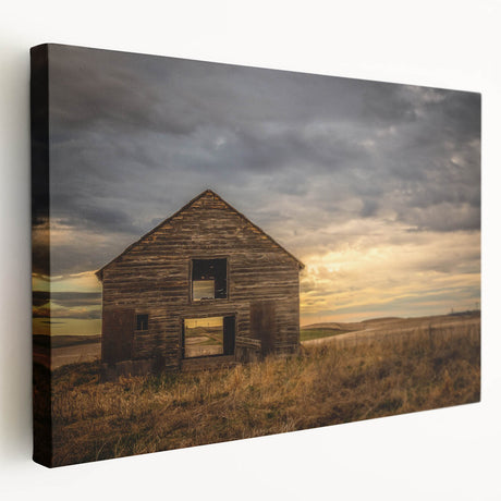 Stretched canvas wall art depicting a serene landscape of red barns set against a vibrant blue sky, ideal for rustic home decor and country-themed interiors.
