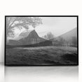 Framed acrylic wall art showcasing a serene landscape with rustic barns, featuring a black frame, perfect for enhancing home decor with a touch of nature.