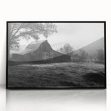 Framed acrylic wall art showcasing a serene landscape with rustic barns, featuring a black frame, perfect for enhancing home decor with a touch of nature.