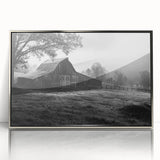 Framed wall art featuring a serene landscape of a rustic barn surrounded by lush greenery, with a sleek silver frame, ideal for home decor enhancement.