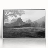 Framed acrylic wall art showcasing a serene rural landscape with a classic red barn, set against a vibrant blue sky and lush green fields, perfect for home decor.