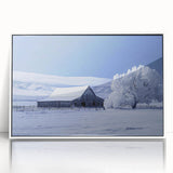 Framed acrylic wall art featuring a serene landscape with a classic red barn, surrounded by lush greenery and a clear blue sky, enhancing rustic home decor.