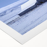 Rolled canvas wall art featuring a serene landscape with a rustic red barn surrounded by lush green fields and a vibrant blue sky, ideal for home decor.