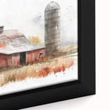 Close-up of a framed canvas wall art piece showcasing a serene landscape with a rustic barn surrounded by vibrant greenery and a clear blue sky, perfect for home decor.
