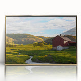 Framed acrylic wall art featuring a scenic landscape of a rustic barn, accented with gold trim, ideal for home decor and farmhouse aesthetics.