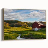 Framed canvas wall art featuring a picturesque landscape with a rustic barn, accented by gold framing. Ideal for farmhouse decor, enhancing any living space.