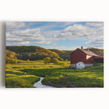Stretched canvas wall art showcasing a vibrant landscape featuring a rustic red barn surrounded by lush green fields and a bright blue sky, perfect for home décor.