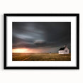 Framed black wall art featuring a picturesque barn landscape design, ideal for rustic decor, with a white mat enhancing its visual appeal.