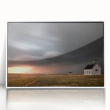 Framed acrylic wall art featuring a serene landscape with rustic barns, set against a vibrant sunset sky, perfect for home decor enthusiasts.