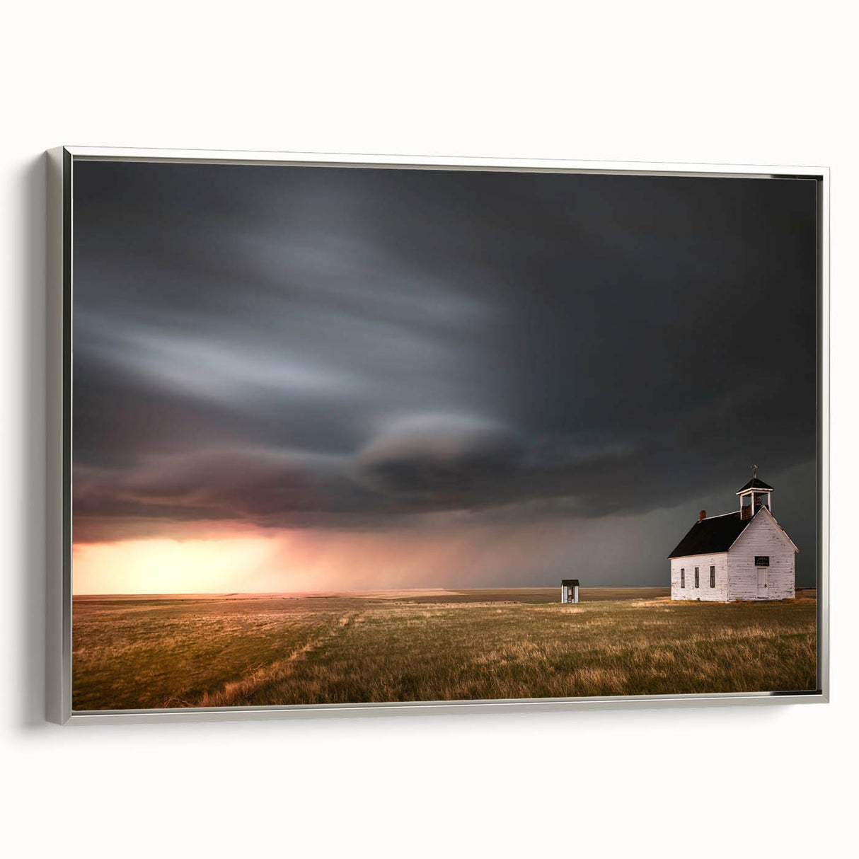 Framed canvas artwork showcasing a serene landscape of rustic barns, with silver accents and a side view, perfect for enhancing home decor with a touch of nature.