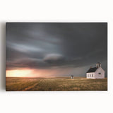 Stretched canvas wall art showcasing a serene landscape with rustic barns against a vibrant sky, ideal for farmhouse decor and nature lovers. The artwork adds a warm touch to any living space.