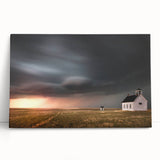 Stretched canvas wall art showcasing a serene rural landscape with a rustic red barn, lush green fields, and a vibrant blue sky, perfect for home decor.