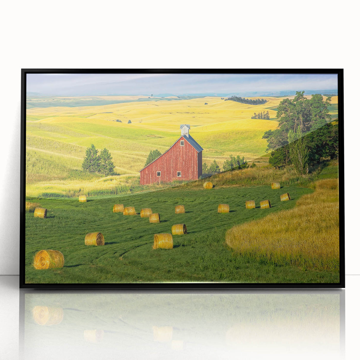 Framed acrylic wall art showcasing a picturesque landscape with a rustic barn, featuring a sleek black frame that enhances the vibrant colors and details, perfect for home decor.