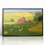 Framed acrylic wall art showcasing a picturesque landscape with a rustic barn, featuring a sleek black frame that enhances the vibrant colors and details, perfect for home decor.