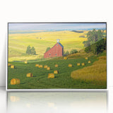 Framed acrylic wall art showcasing a serene landscape with rustic barns, presented in a white frame, ideal for home decor enthusiasts seeking nature-inspired designs.