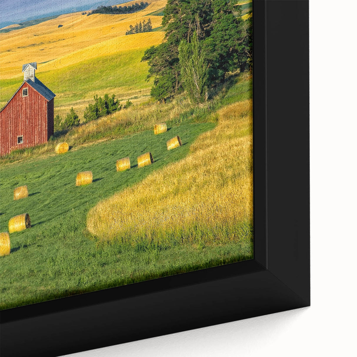 Framed canvas wall art showcasing a rustic barn landscape with vibrant green fields and a clear blue sky, offering a serene rural aesthetic for home decor.