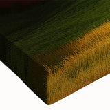 Close-up of a stretched canvas featuring a vibrant landscape with rustic barns, showcasing rich colors and intricate details, ideal for home decor.