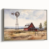 Framed wall art showcasing a serene landscape with rustic barns under a clear blue sky, featuring silver framing for an elegant touch, perfect for home decor.