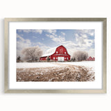 Framed wall art featuring a serene landscape with a rustic barn design, showcased in a silver frame with a white mat, ideal for enhancing home decor.