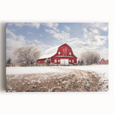 Stretched canvas wall art showcasing a vibrant landscape featuring a rustic red barn surrounded by lush green fields and a clear blue sky, perfect for home decor.
