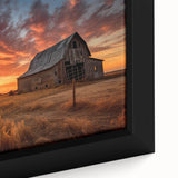 Framed canvas wall art collection showcasing a serene landscape featuring rustic barns under a vibrant sunset, enhancing home decor with natural beauty and warmth.