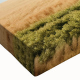 Close-up of a stretched canvas wall art piece depicting a serene landscape with a rustic barn, rich colors of green and brown, ideal for country-themed decor.