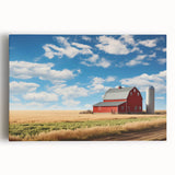 Stretched canvas artwork showcasing a vibrant landscape with rustic barns, lush green fields, and a clear blue sky, perfect for home decor.