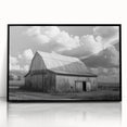 Framed acrylic wall art featuring a serene landscape with a rustic barn, presented in a sleek black frame, perfect for enhancing home decor with a touch of countryside charm.