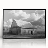 Framed acrylic wall art featuring a serene landscape with a rustic barn, presented in a sleek black frame, perfect for enhancing home decor with a touch of countryside charm.