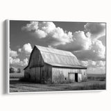 Framed canvas wall art depicting a serene landscape featuring rustic barns under a vibrant sunset sky, showcasing warm hues of orange and yellow, perfect for home decor.
