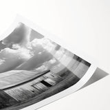 Vibrant landscape wall art print showcasing a rustic red barn set against a picturesque countryside backdrop, perfect for enhancing home decor with a touch of rural charm.