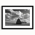 Framed black wall art showcasing a serene landscape with rustic barns, highlighting earthy tones and a modern design, perfect for enhancing home decor.