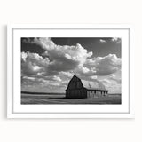 Framed landscape wall art depicting serene barn scenery in soft earth tones, showcasing a white mat and sleek frame, ideal for rustic home decor.