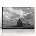 Framed acrylic wall art of a serene landscape showcasing a rustic barn against a vibrant sunset, featuring a sleek black frame, ideal for home decor.