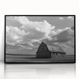 Framed acrylic wall art of a serene landscape showcasing a rustic barn against a vibrant sunset, featuring a sleek black frame, ideal for home decor.