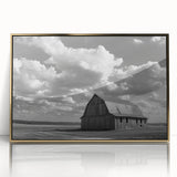 Framed acrylic wall art showcasing a picturesque landscape with a rustic barn, set in a gold frame, perfect for enhancing home decor and adding warmth to any room.