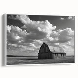 Framed canvas wall art showcasing a scenic landscape with a rustic barn, complemented by a white frame, perfect for home decor in country-themed interiors.