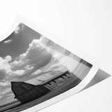 Rustic landscape wall art featuring a serene barn scene with vibrant green fields and a clear blue sky, rolled for easy display and shipping. Perfect for farmhouse decor.