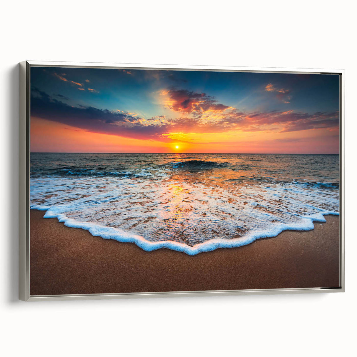 Framed canvas wall art showcasing a serene beach landscape with vibrant colors, featuring silver accents along the edges, perfect for coastal-themed decor.