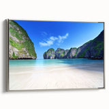 Framed canvas wall art showcasing a serene beach landscape with vibrant colors, set in a sleek silver frame, perfect for enhancing home decor.