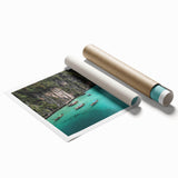 Vibrant rolled wall art print showcasing a serene beach landscape, featuring soft blue waves, golden sand, and a clear sky, perfect for home decor.