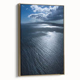 Framed canvas wall art depicting a serene beach landscape, showcasing vibrant blue waters and golden sands, perfect for enhancing home decor with a coastal theme.