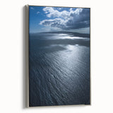 Framed canvas wall art showcasing a serene beach landscape with vibrant colors, silver frame, and sleek side view, perfect for enhancing home decor.