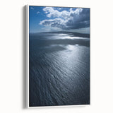 Framed canvas wall art showcasing a serene beach landscape design, featuring soft pastel colors and a white frame, perfect for coastal-themed decor.