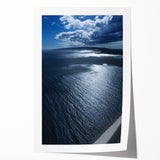 Vibrant rolled print of a serene beach landscape, showcasing soft waves and golden sand under a clear blue sky, ideal for home decor and relaxation.